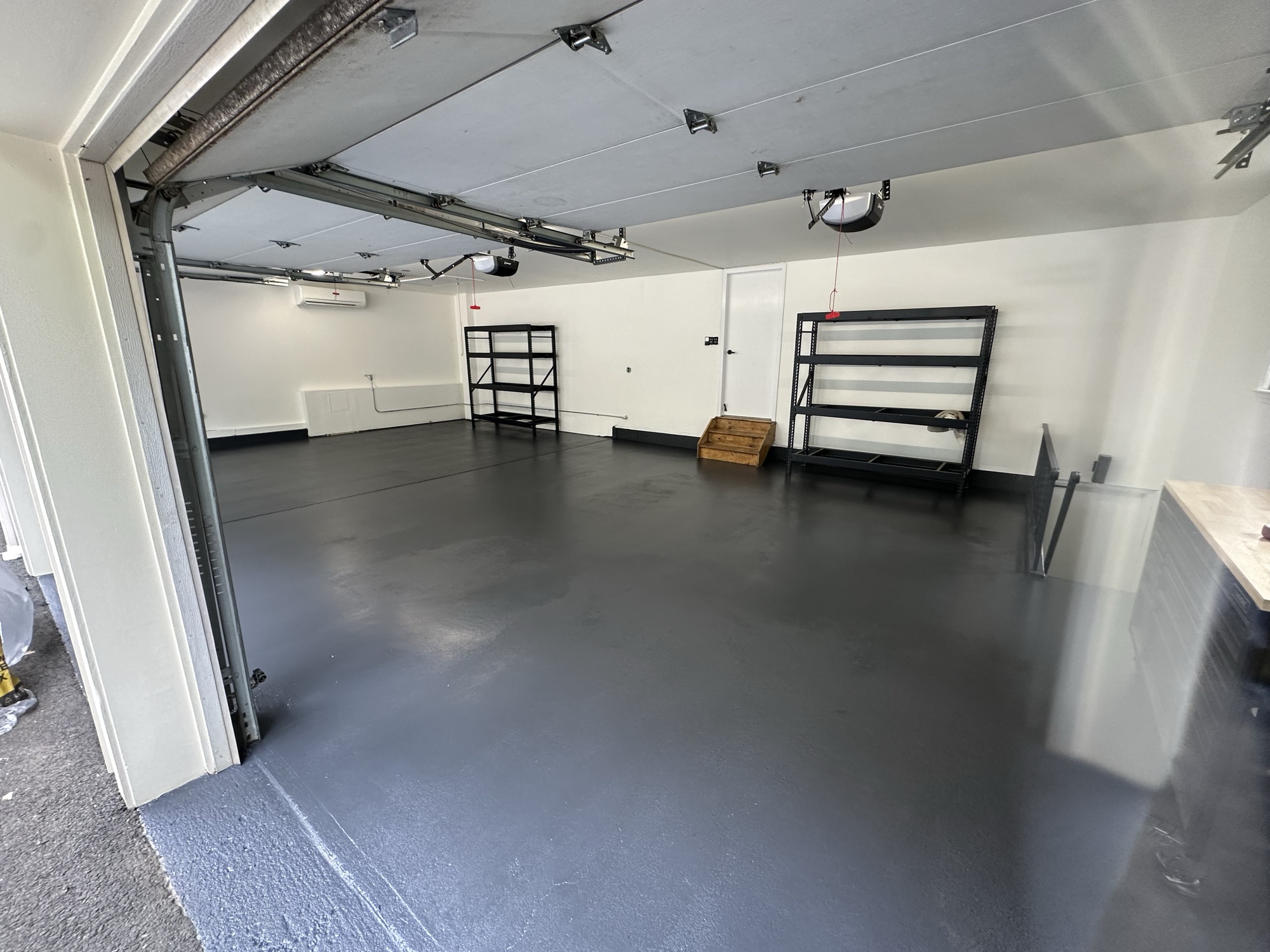 Epoxy garage floor with clean finish by J&B Painting
