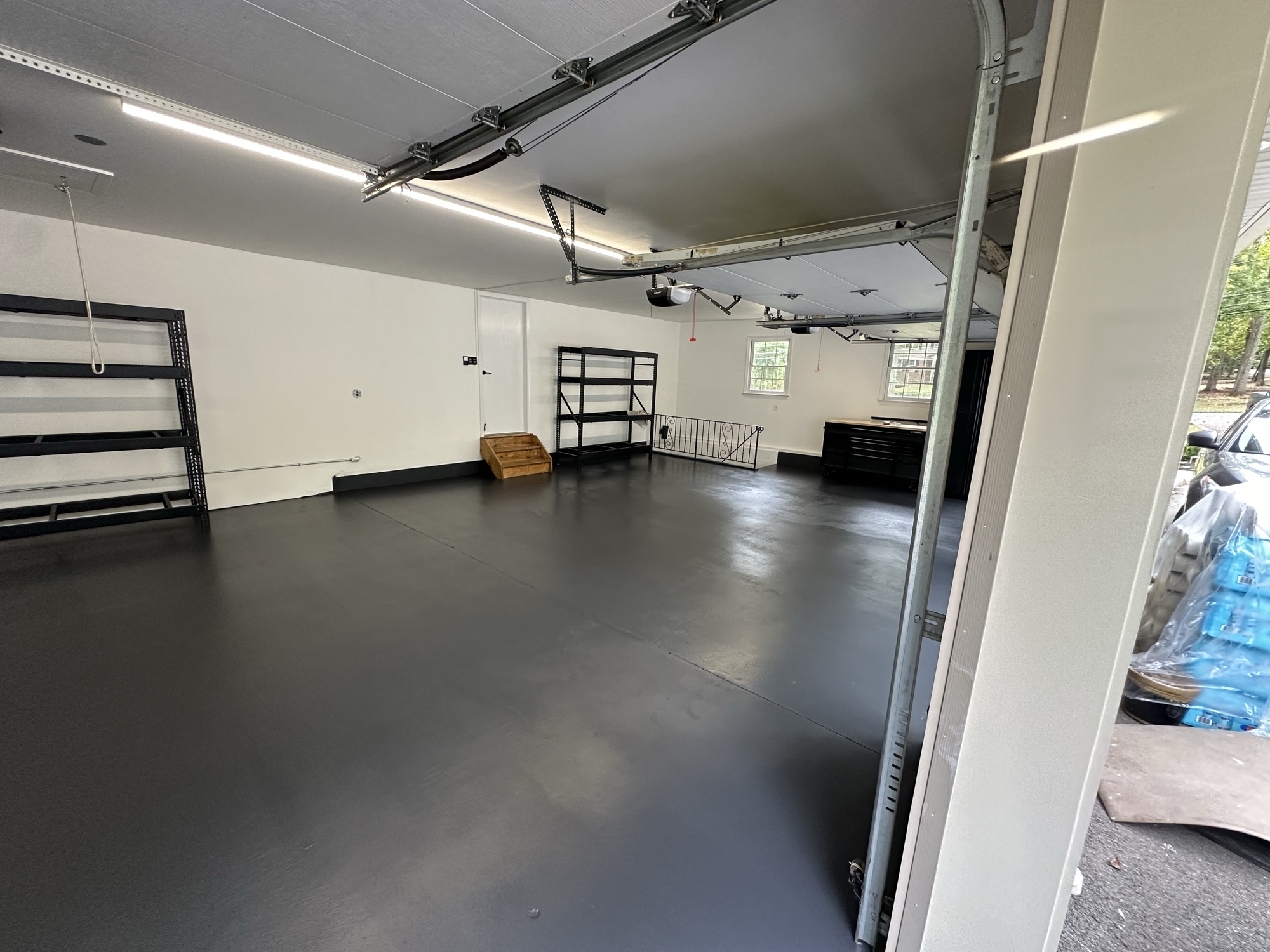 Sleek dark gray epoxy garage floor by J&B Painting