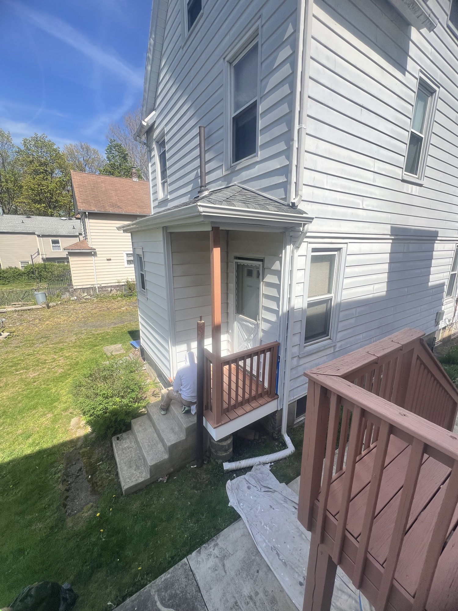 Brown stained porch landing with railings by J&B Painting