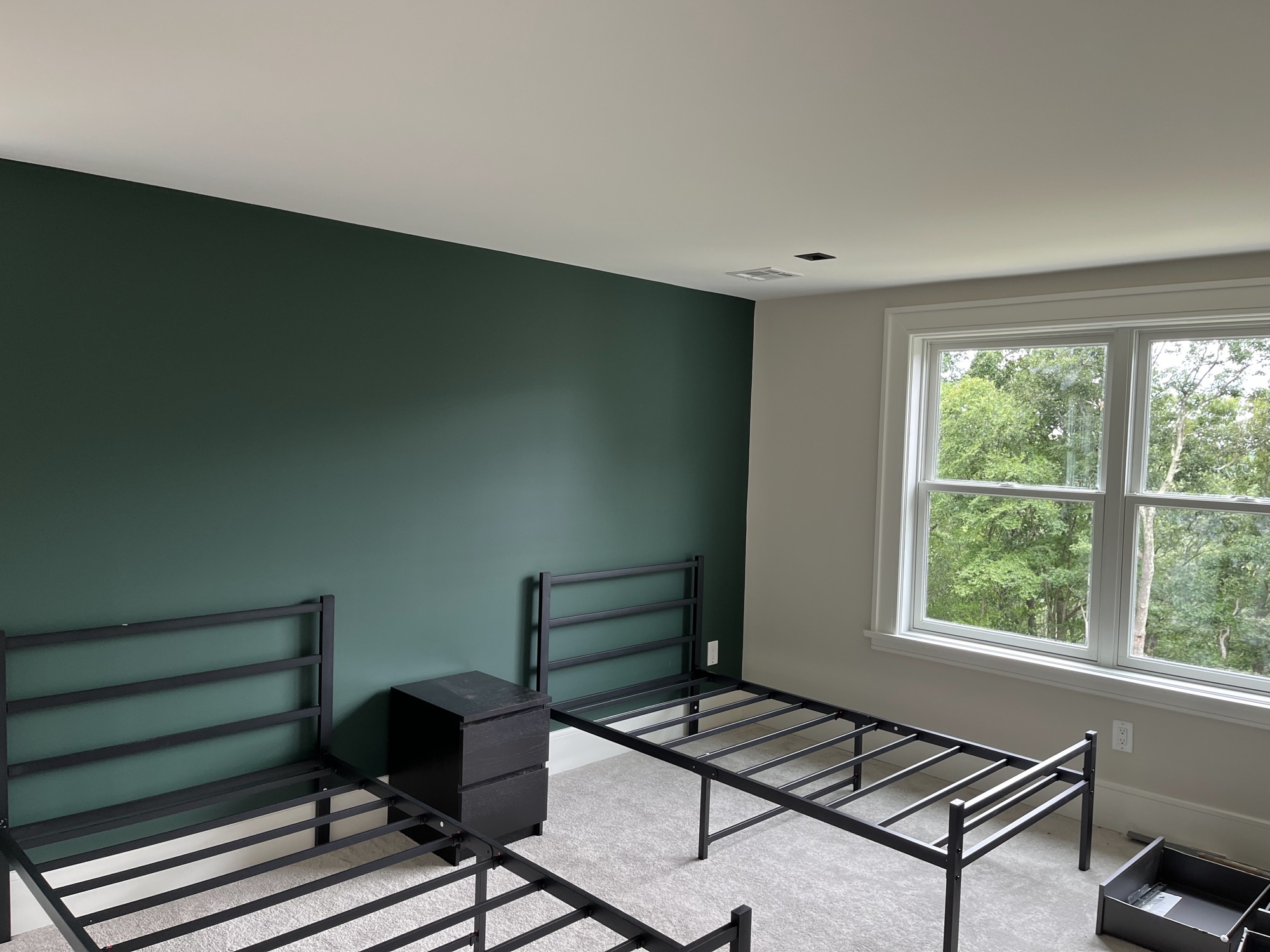 Bedroom with deep green accent wall, modern style