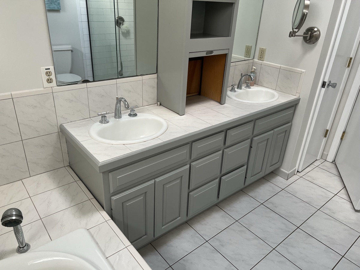 Gray painted bathroom vanity with double sinks