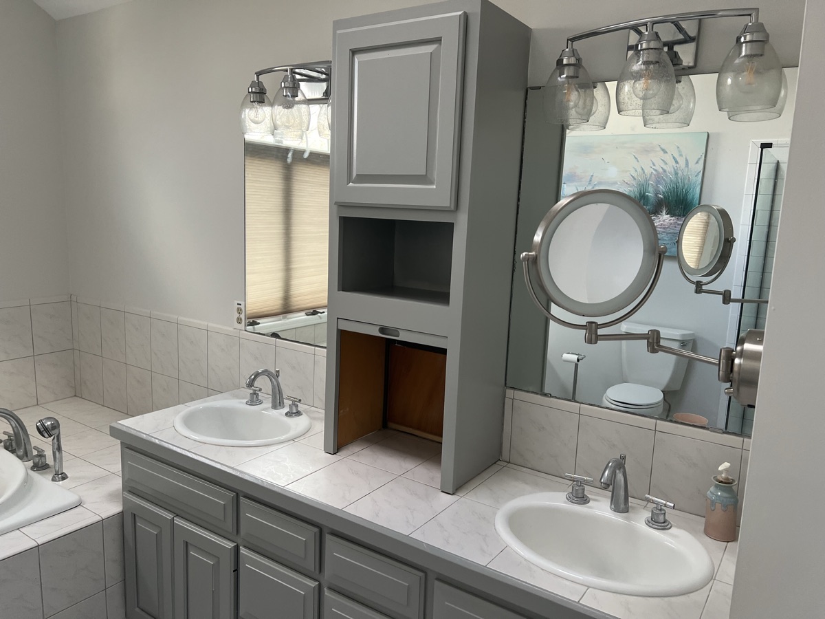 Painted gray vanity with storage tower close-up