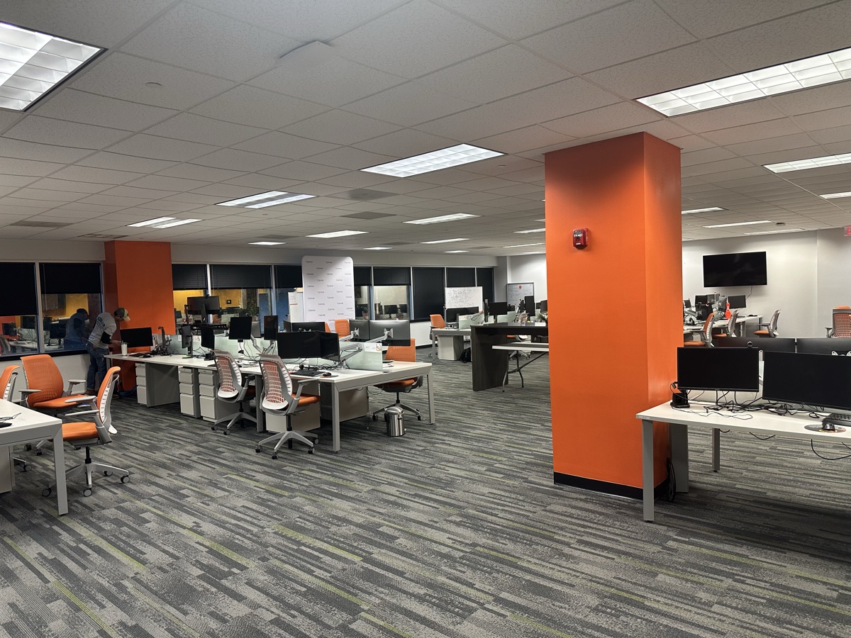 Open office with orange accent columns and workstations