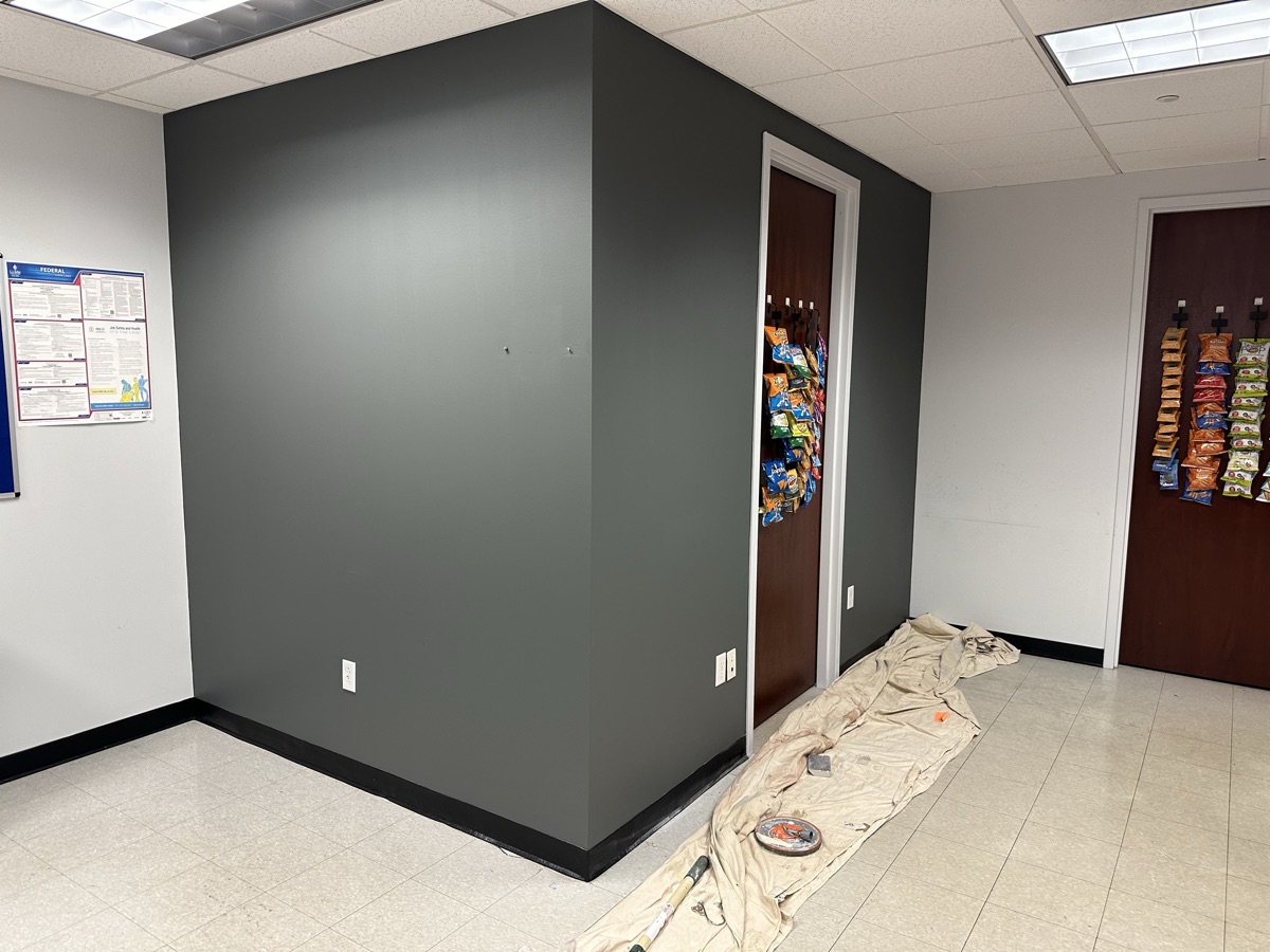 Break room with dark charcoal accent wall by J&B Painting