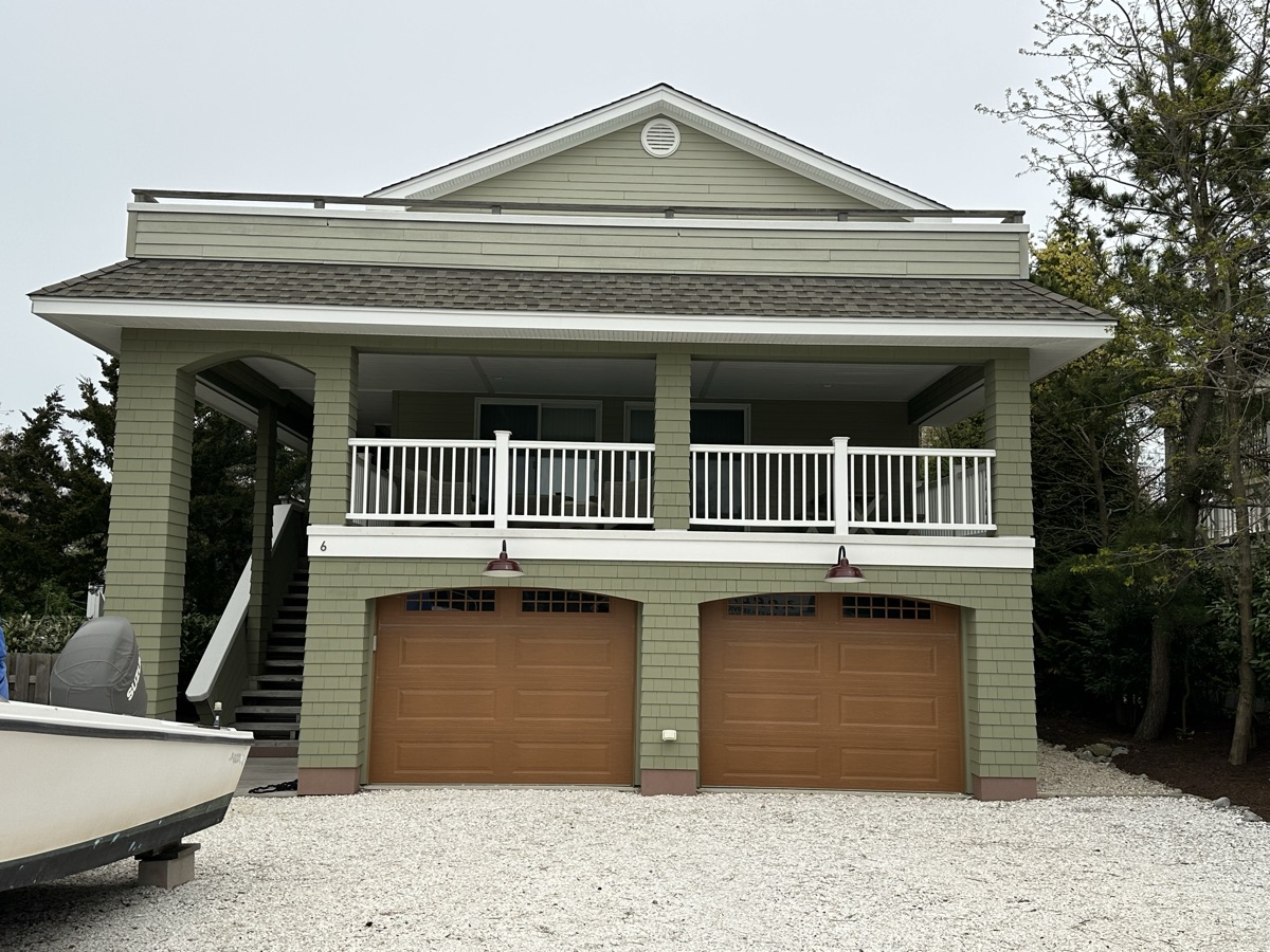 Green coastal home with balcony alternate view by J&B Painting