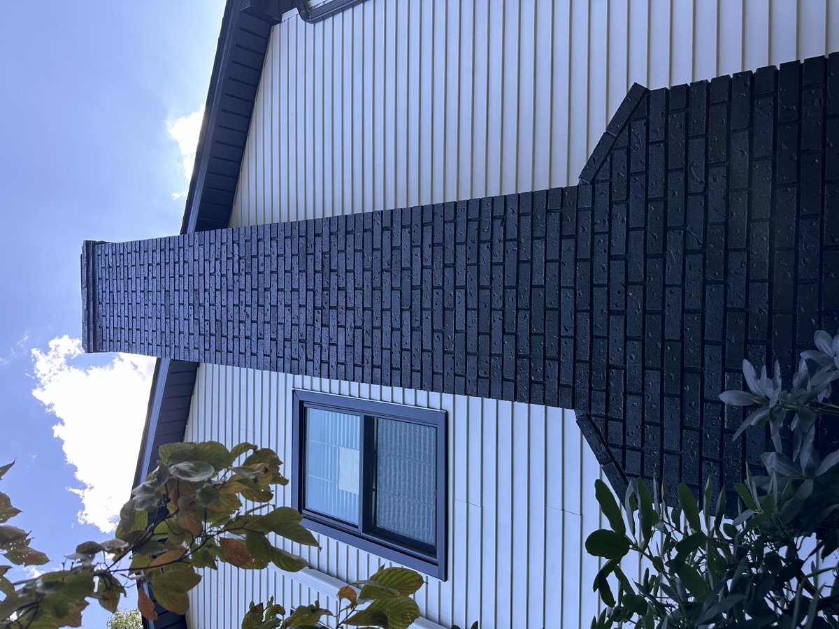 Two-tone exterior with dark painted brick accent by J&B Painting