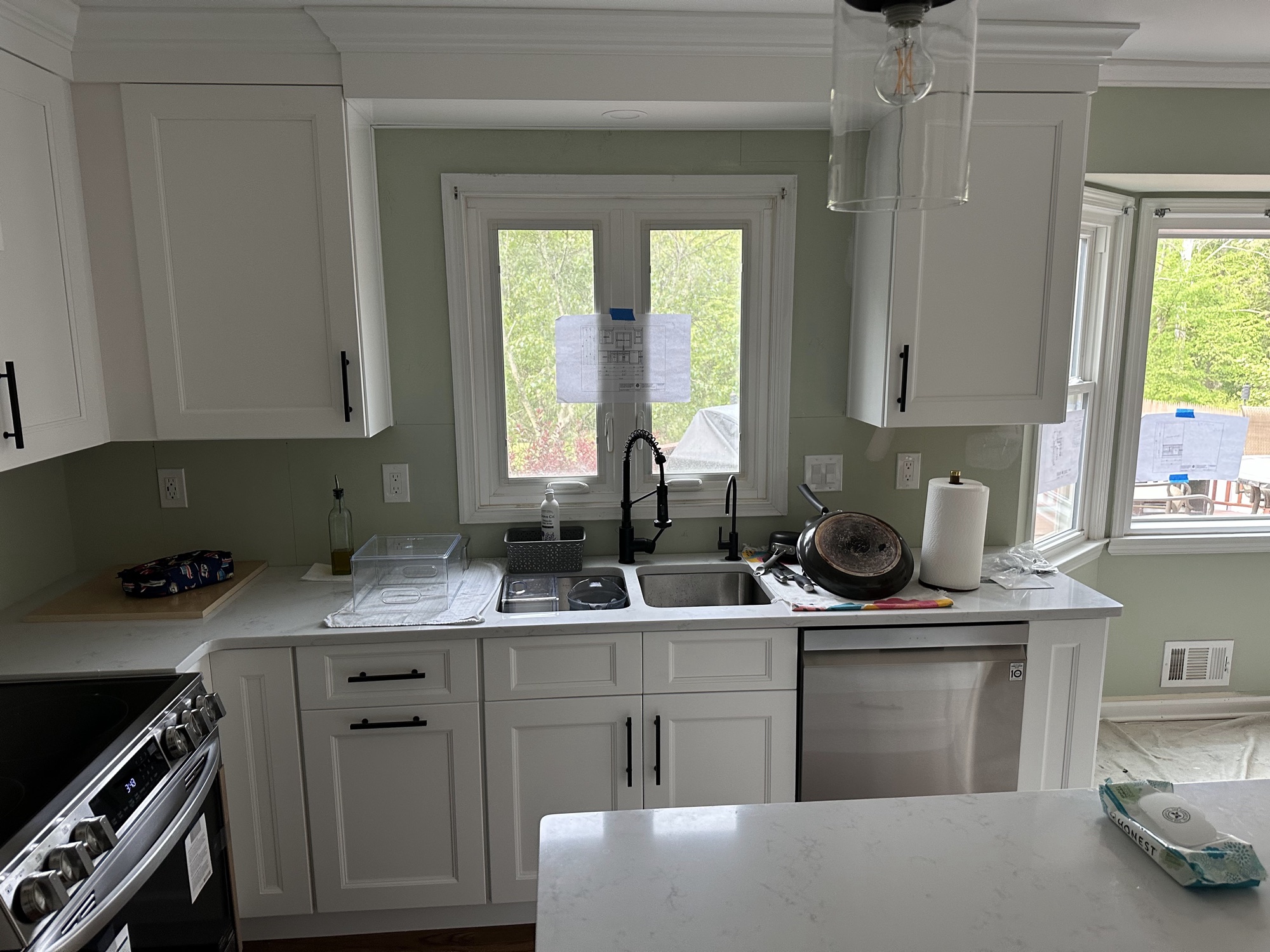 White kitchen cabinets with sage green walls