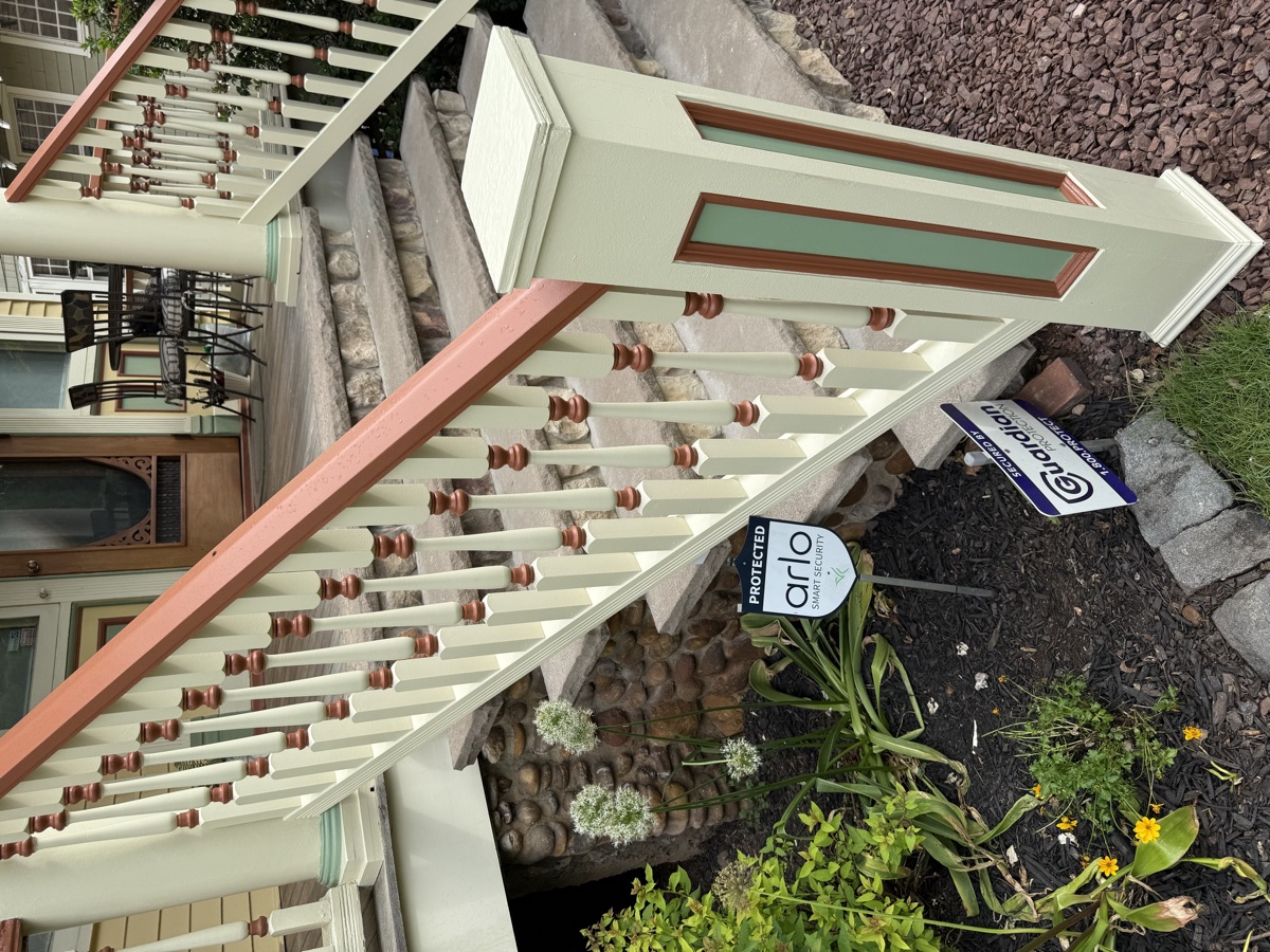 Craftsman porch restoration with painted railings and stone pillars by J&B Painting