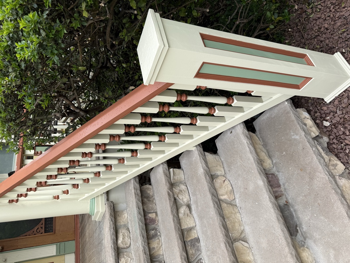 Restored porch railing detail with stone column by J&B Painting