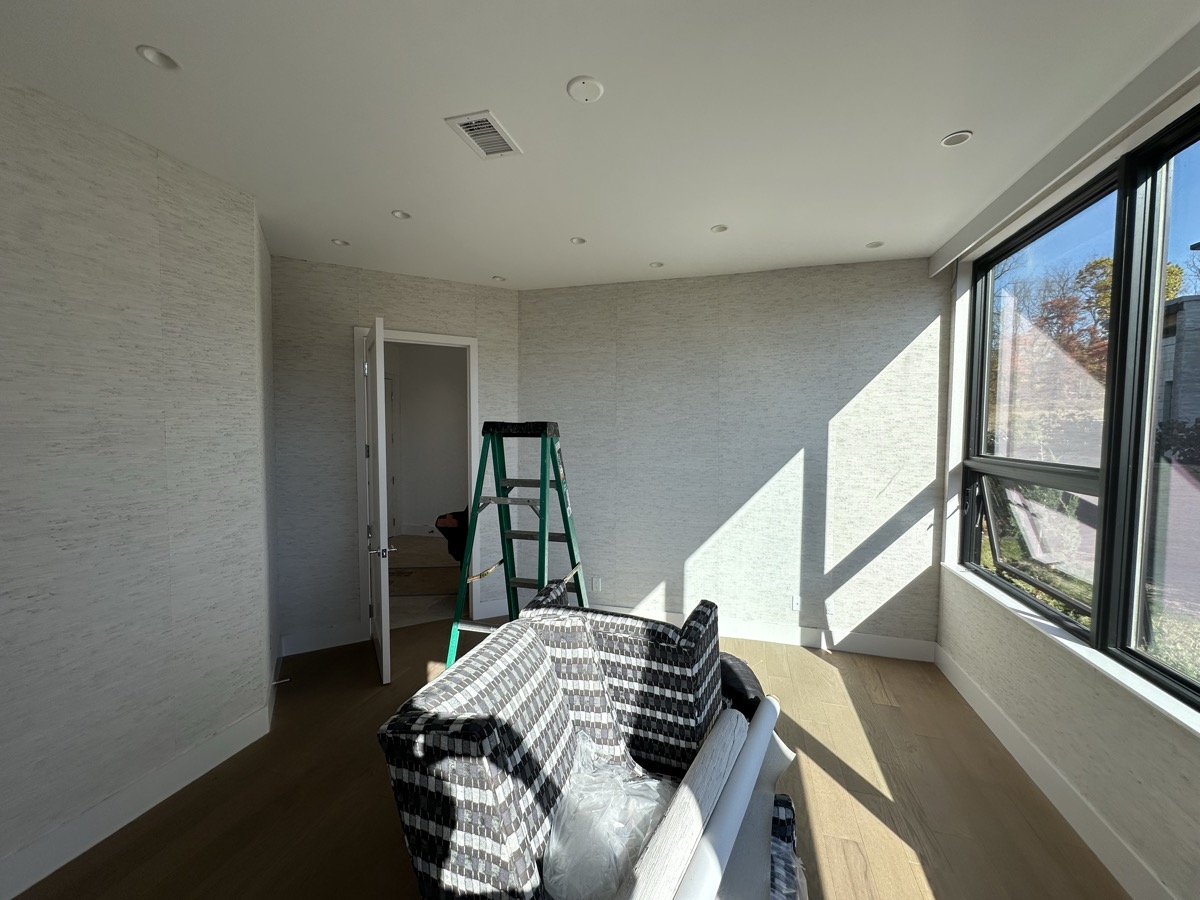 Textured neutral wallpaper with natural sunlight in modern room