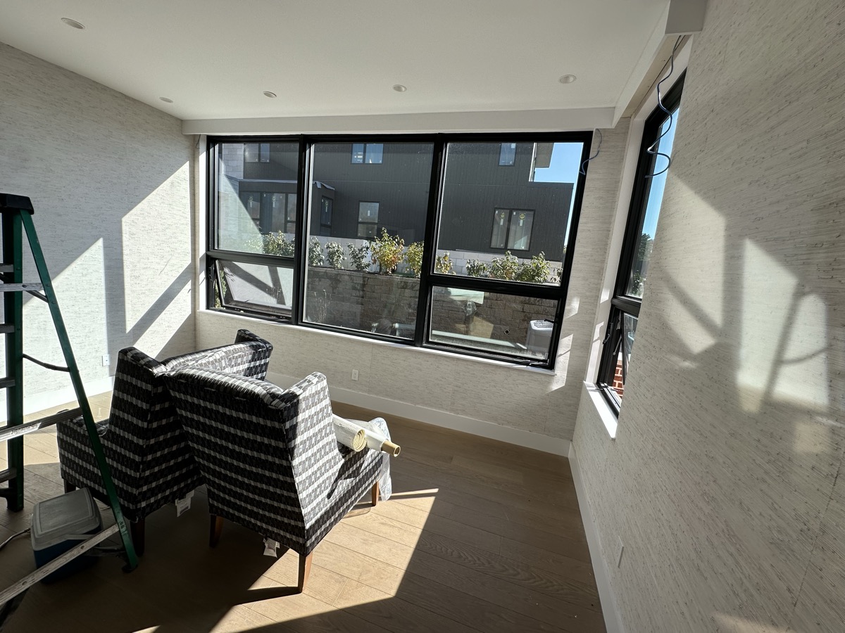 Textured wallpaper installation with window view in Central New Jersey home